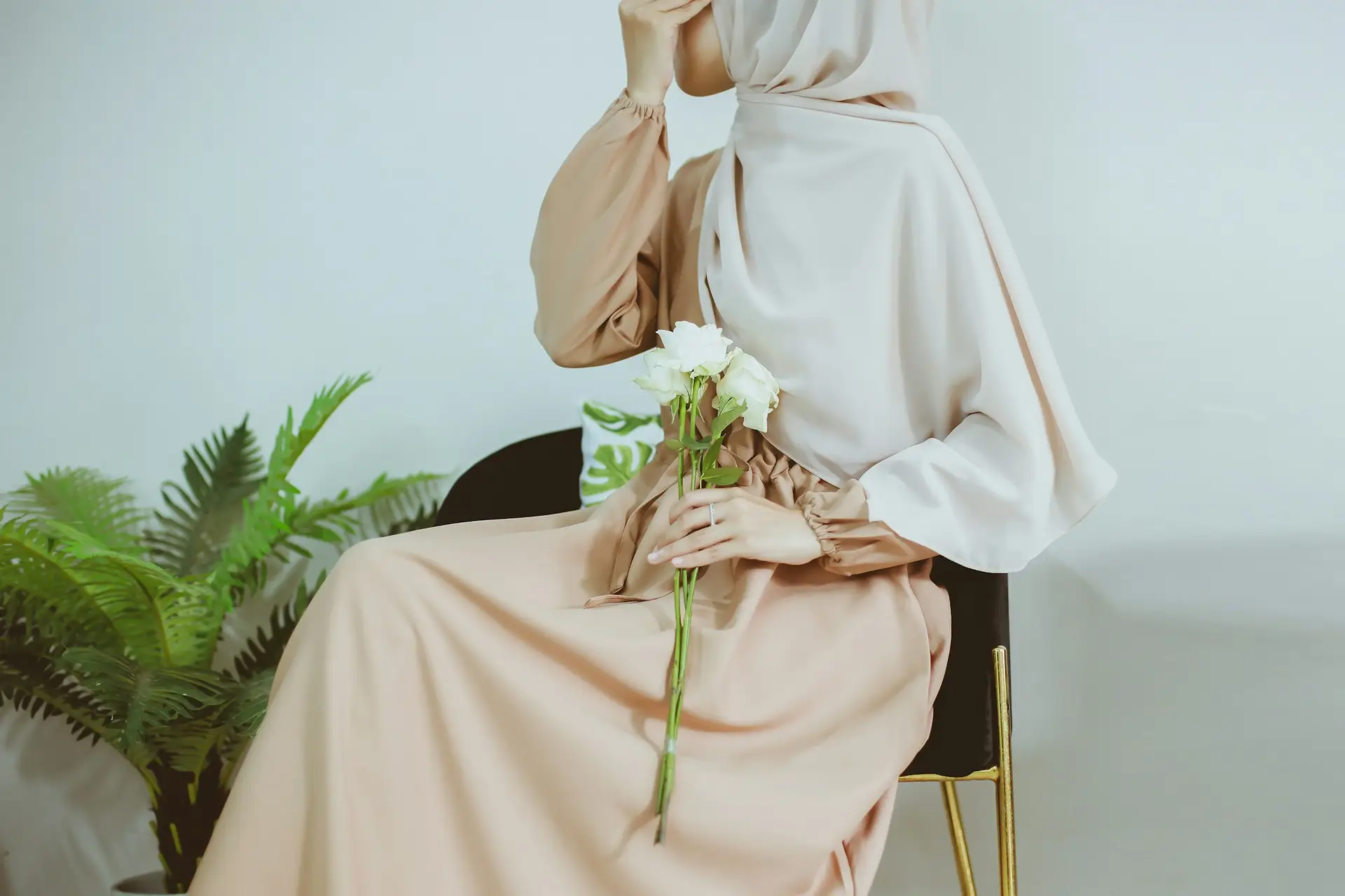 Muslim Woman holding white roses